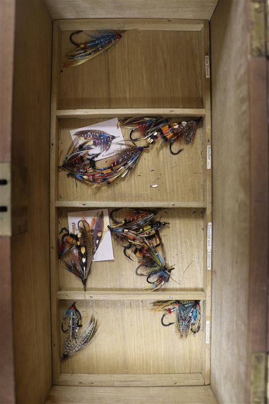 A fitted box containing seven trays of salmon fishing flies